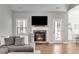 Comfortable living room with stone fireplace, a large window, and access to outdoor space at 728 Harmony Rd, Temple, GA 30179