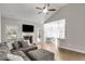 Open-concept living room with fireplace, ceiling fan and view of the dining area at 728 Harmony Rd, Temple, GA 30179