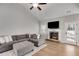 Spacious living room featuring vaulted ceiling, stone fireplace, and a large comfortable sofa at 728 Harmony Rd, Temple, GA 30179
