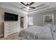 Main bedroom with tray ceiling, ceiling fan, and en-suite bathroom at 728 Harmony Rd, Temple, GA 30179