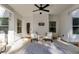 Covered patio with ceiling fan, two chairs and door leading to inside at 728 Harmony Rd, Temple, GA 30179