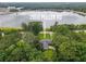 Aerial view of a lakeside home surrounded by lush trees at 2808 Peeler Rd, Dunwoody, GA 30360
