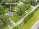 Aerial view of a home with a sprawling lawn and mature trees by the lake at 2808 Peeler Rd, Dunwoody, GA 30360