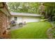 Outdoor patio space featuring a grill and a spacious grassy backyard at 2808 Peeler Rd, Dunwoody, GA 30360