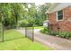 Spacious backyard with a fence, basketball court, and mature trees at 2808 Peeler Rd, Dunwoody, GA 30360