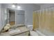 Bathroom featuring granite countertop, single sink vanity, and bath-shower combination at 2808 Peeler Rd, Dunwoody, GA 30360