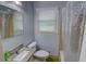 Cozy bathroom with granite countertops, a shower, and a decorative mirror at 2808 Peeler Rd, Dunwoody, GA 30360