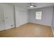 Bedroom featuring hardwood floors, ceiling fan, and closet with paneled doors at 2808 Peeler Rd, Dunwoody, GA 30360