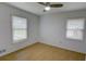Bright bedroom featuring hardwood floors, two windows, and a ceiling fan at 2808 Peeler Rd, Dunwoody, GA 30360