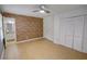 Spacious bedroom with wood flooring, closet, and brick detail near the bathroom at 2808 Peeler Rd, Dunwoody, GA 30360