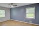 Bright bedroom with hardwood floors, ceiling fan, and large windows offering natural light at 2808 Peeler Rd, Dunwoody, GA 30360