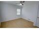 Well-lit bedroom featuring hardwood floors, one window, and a ceiling fan at 2808 Peeler Rd, Dunwoody, GA 30360