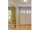 Inviting entryway with beautiful wood floors and a charming decorative plant at 2808 Peeler Rd, Dunwoody, GA 30360