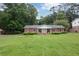 Charming brick home with a well-manicured lawn and mature trees at 2808 Peeler Rd, Dunwoody, GA 30360