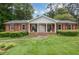 Charming one-story brick home with a large front yard and inviting columned porch at 2808 Peeler Rd, Dunwoody, GA 30360