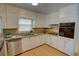 Bright kitchen featuring stainless steel appliances, granite countertops, and white cabinets at 2808 Peeler Rd, Dunwoody, GA 30360