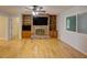 Spacious living room with hardwood floors, a brick fireplace, and built-in bookshelves at 2808 Peeler Rd, Dunwoody, GA 30360