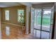 Spacious living room with hardwood floors, ample natural light, and an open doorway at 2808 Peeler Rd, Dunwoody, GA 30360