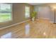 Sun-filled living room featuring hardwood floors, large windows, and warm neutral paint tones at 2808 Peeler Rd, Dunwoody, GA 30360