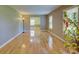 Bright living room with gleaming hardwood floors and large windows, a cozy lamp and plant at 2808 Peeler Rd, Dunwoody, GA 30360
