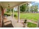 Covered porch with classic columns offering a peaceful view of the landscaped front yard at 2808 Peeler Rd, Dunwoody, GA 30360