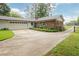 Exterior of a home with a long driveway and a detached garage at 2808 Peeler Rd, Dunwoody, GA 30360