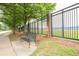 Scenic street view with iron fence and park bench near the lake at 2808 Peeler Rd, Dunwoody, GA 30360