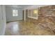 Cozy sunroom featuring brick walls and tiled floor offering natural light at 2808 Peeler Rd, Dunwoody, GA 30360