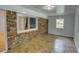 Inviting sunroom with brick accent wall, tile flooring, and bright natural light at 2808 Peeler Rd, Dunwoody, GA 30360
