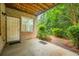 View of a covered back patio leading to a yard area bordered by lush greenery at 3130 Woodwalk Se Trce # 8, Atlanta, GA 30339