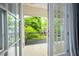 A serene balcony view with French doors, overlooking lush greenery and a charming neighborhood at 3130 Woodwalk Se Trce # 8, Atlanta, GA 30339