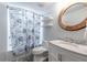 Bathroom featuring a tub with shower curtain, a vanity, and a decorative mirror at 3130 Woodwalk Se Trce # 8, Atlanta, GA 30339