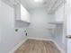 Bright laundry room with tile floors, white walls, storage, and washer/dryer hookups at 3130 Woodwalk Se Trce # 8, Atlanta, GA 30339