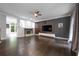 Spacious living room featuring hardwood floors, a fireplace, and a modern media center at 3130 Woodwalk Se Trce # 8, Atlanta, GA 30339