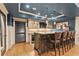 Elegant basement bar area featuring a granite countertop, seating, and custom cabinetry at 3750 Maryhill Nw Ln, Kennesaw, GA 30152