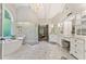 A spacious bathroom with soaking tub, glass shower, vanity, and marble floors awaits at 3750 Maryhill Nw Ln, Kennesaw, GA 30152