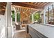 Relaxing covered patio with a stone fireplace, outdoor seating, and a hot tub for entertainment at 3750 Maryhill Nw Ln, Kennesaw, GA 30152