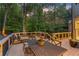 Spacious outdoor deck with dining and lounging areas perfect for entertaining amidst a lush, wooded landscape at 3750 Maryhill Nw Ln, Kennesaw, GA 30152