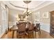 Formal dining room featuring hardwood floors, a chandelier, and a wooden dining table with seating at 3750 Maryhill Nw Ln, Kennesaw, GA 30152