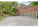 Spacious driveway leading to a three-car garage, complemented by a basketball hoop and a well-maintained lawn at 3750 Maryhill Nw Ln, Kennesaw, GA 30152