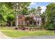 Charming two-story brick home with a welcoming front porch and meticulously maintained landscaping at 3750 Maryhill Nw Ln, Kennesaw, GA 30152