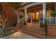 Charming brick home entrance featuring double doors, elegant columns, and manicured landscaping at dusk at 3750 Maryhill Nw Ln, Kennesaw, GA 30152