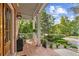 Cozy front porch showcasing brick flooring, decorative plants, and a view of the well-manicured front yard at 3750 Maryhill Nw Ln, Kennesaw, GA 30152