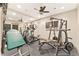 Home gym with exercise equipment, a full-length mirror, and a ceiling fan at 3750 Maryhill Nw Ln, Kennesaw, GA 30152