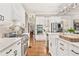 Well-equipped kitchen with stainless steel appliances, marble countertops, and a view of the adjacent living spaces at 3750 Maryhill Nw Ln, Kennesaw, GA 30152