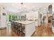 Bright kitchen with a large center island, white cabinetry, stainless steel appliances, and a view of the backyard at 3750 Maryhill Nw Ln, Kennesaw, GA 30152