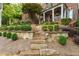 Stone steps lead up to this gorgeous home, surrounded by neatly trimmed bushes and manicured landscaping at 3750 Maryhill Nw Ln, Kennesaw, GA 30152