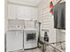 Well-organized laundry room with white cabinets, appliances, and functional storage solutions at 3750 Maryhill Nw Ln, Kennesaw, GA 30152