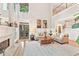 Bright living room with fireplace, soaring ceilings, hardwood floors, and an abundance of natural light at 3750 Maryhill Nw Ln, Kennesaw, GA 30152