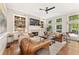 Cozy living room with hardwood floors, fireplace, custom built-ins, and plenty of natural light at 3750 Maryhill Nw Ln, Kennesaw, GA 30152